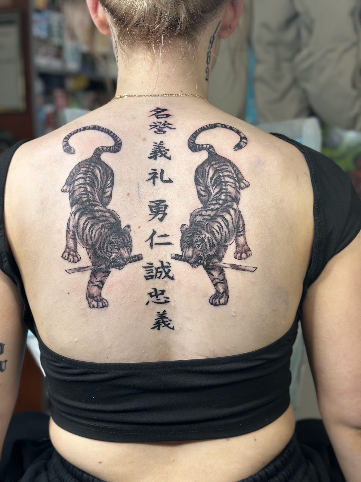 Twin tigers: Upper back, tigers with script